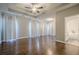 Large main bedroom with hardwood floors, ceiling fan, and access to bathroom at 6204 Woodlore Nw Dr, Acworth, GA 30101