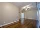 Bright main bedroom with hardwood floors, ceiling fan and neutral walls at 6204 Woodlore Nw Dr, Acworth, GA 30101