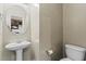 Small powder room with pedestal sink and toilet at 1410 Metropolitan Sw Pkwy, Atlanta, GA 30310