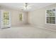 Spacious bedroom with carpeting, large windows, and private door to deck at 1410 Metropolitan Sw Pkwy, Atlanta, GA 30310