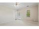 Bright bedroom featuring a ceiling fan, private door, and ample natural light at 1410 Metropolitan Sw Pkwy, Atlanta, GA 30310