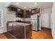 Modern kitchen with stainless steel appliances and dark cabinets at 1410 Metropolitan Sw Pkwy, Atlanta, GA 30310