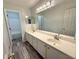 Double vanity bathroom with large mirror and grey flooring at 4010 Bradstone Nw Trce, Lilburn, GA 30047