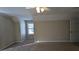 Spacious bedroom with a window, carpet, and ceiling fan at 106 Ashwood N Ct, Stockbridge, GA 30281