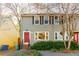 Two story light taupe townhouse with red door, and landscaping at 8 Holly Downs Nw Ct, Atlanta, GA 30318