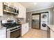 Kitchen with white cabinets, granite countertops, and stainless steel appliances at 8 Holly Downs Nw Ct, Atlanta, GA 30318