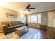 Living room with hardwood floors, gray couch, and ceiling fan at 8 Holly Downs Nw Ct, Atlanta, GA 30318