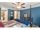 Spacious bedroom with blue walls, a four-poster bed, and ceiling fan at 1634 Ponce De Leon Ne Ave # 506, Atlanta, GA 30307