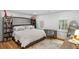 bedroom with built-in shelves, hardwood floors, and a large bed at 3220 Farmington Se Dr, Atlanta, GA 30339