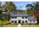 Two-story white brick house with black shutters, a gray roof, and a walkway at 3220 Farmington Se Dr, Atlanta, GA 30339