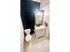 Updated powder room with dark accent wall and white vanity at 4846 Twin Lakes Trl, Atlanta, GA 30360