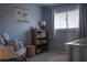 Bedroom with rocking chair, bookshelf, and neutral color scheme at 4846 Twin Lakes Trl, Atlanta, GA 30360