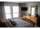 Spacious bedroom with large windows, dresser, and comfortable bedding at 4846 Twin Lakes Trl, Atlanta, GA 30360