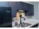 Kitchen sink and appliances with dark cabinets at 4846 Twin Lakes Trl, Atlanta, GA 30360