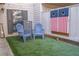 Small patio with artificial turf, two chairs, and cornhole boards at 4846 Twin Lakes Trl, Atlanta, GA 30360