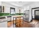 Modern kitchen with white cabinets, green tile backsplash, and stainless steel appliances at 836 Dill Sw Ave, Atlanta, GA 30310