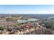 Aerial view of house near a lake in a secluded community at 66 Trevor Way, Temple, GA 30179