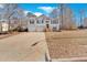 Tan house with a two-car garage and a view of the front yard at 66 Trevor Way, Temple, GA 30179