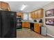 Modern kitchen featuring black appliances and ample wood cabinets at 66 Trevor Way, Temple, GA 30179