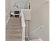 Carpeted staircase leading to an upper level, with a view of the living room in the background at 66 Trevor Way, Temple, GA 30179