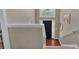 View from the top of a carpeted staircase, looking down to the front entryway at 66 Trevor Way, Temple, GA 30179