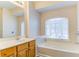 Bathroom with wood vanity and bathtub at 962 Pierce Ivy Ct, Lawrenceville, GA 30043