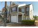Two-story townhome with stone accents and a two-car garage at 962 Pierce Ivy Ct, Lawrenceville, GA 30043