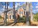 Two story brick house with black shutters, nestled amongst tall trees at 1772 Benningfield Dr, Marietta, GA 30064