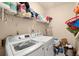 Laundry room with washer, dryer, and shelving for storage at 1772 Benningfield Dr, Marietta, GA 30064