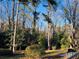 Wooded backyard with tall trees and a grassy area at 4817 Carlene Sw Way, Lilburn, GA 30047