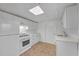 Basement kitchenette with white cabinetry and appliances at 4817 Carlene Sw Way, Lilburn, GA 30047