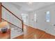 Hardwood floor entryway with staircase, white door and trim at 4817 Carlene Sw Way, Lilburn, GA 30047