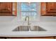 Modern kitchen sink with a sleek, gold faucet and white countertop at 4817 Carlene Sw Way, Lilburn, GA 30047