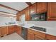 Kitchen with wood cabinets, tile floors and gas cooktop at 4817 Carlene Sw Way, Lilburn, GA 30047