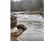 Serene river flowing through a wooded area at 4817 Carlene Sw Way, Lilburn, GA 30047