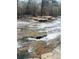 Rocky river with shallow rapids and lush forest at 4817 Carlene Sw Way, Lilburn, GA 30047