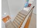 Indoor staircase with carpeted steps and wooden railing at 4817 Carlene Sw Way, Lilburn, GA 30047