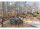 A large wood deck features chairs and tables surrounded by mature trees at 3639 Fowler Rdg, Douglasville, GA 30135