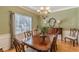 Elegant dining room with a classic chandelier and large window for natural light at 3639 Fowler Rdg, Douglasville, GA 30135