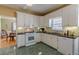 Bright kitchen with white cabinets, black countertops, and stainless steel appliances at 3639 Fowler Rdg, Douglasville, GA 30135