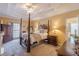 Bedroom featuring a four-poster bed, ceiling fan, and private bathroom at 3639 Fowler Rdg, Douglasville, GA 30135