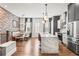 Open concept kitchen and dining area with exposed brick and marble island at 4462 Dandelion Ln, Atlanta, GA 30342