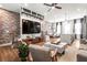 Open living space featuring a large TV, marble coffee table, and brick accent wall at 4462 Dandelion Ln, Atlanta, GA 30342