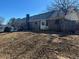 Rear view of brick home with deck and yard at 144 Rockbridge Sw Rd, Lilburn, GA 30047