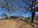 Ranch house nestled amongst mature trees at 144 Rockbridge Sw Rd, Lilburn, GA 30047