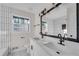 Modern bathroom with double vanity, black matte fixtures, and white subway tile at 2933 Edna Ln, Decatur, GA 30032