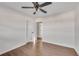 Well-lit bedroom with hardwood floors and ceiling fan, access to hallway at 2933 Edna Ln, Decatur, GA 30032