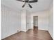 Spacious bedroom with hardwood floors, ceiling fan, and white brick accent wall at 2933 Edna Ln, Decatur, GA 30032