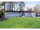 Newly renovated home featuring a gray brick facade, stylish shutters, and a welcoming front porch at 2933 Edna Ln, Decatur, GA 30032