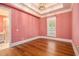 Spacious bedroom with hardwood floors and pink walls at 318 Liberty Ln, Canton, GA 30114